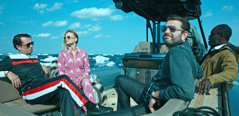 Characters played by Matthew Rhys, Heather Graham, Alexander Sokovikov and Noel Arthur on an open-air boat in an ice floe in the Apple TV+ show 