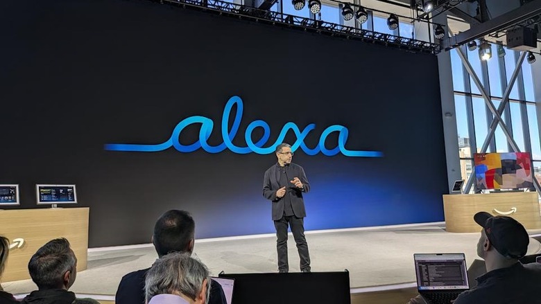 Alexa logo on a screen behind Panos Panay