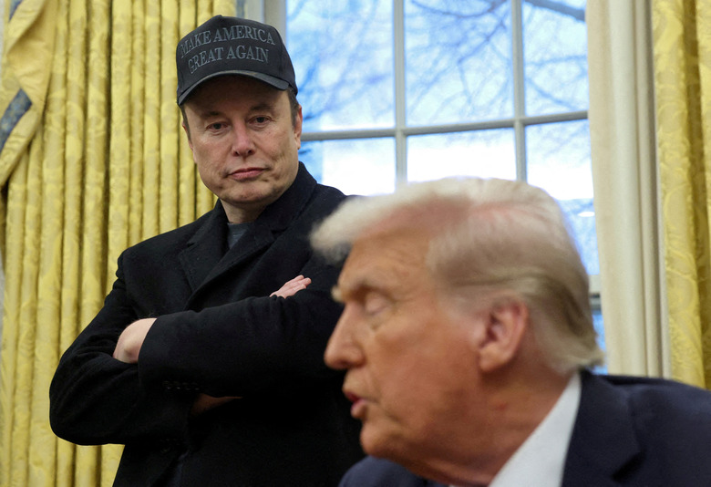 FILE PHOTO: Elon Musk listens to U.S. President Donald Trump speak in the Oval Office of the White House in Washington, D.C., U.S., February 11, 2025. REUTERS/Kevin Lamarque/File Photo