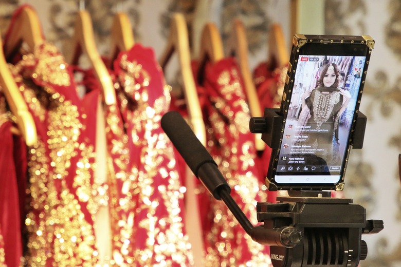 DHAKA, BANGLADESH - 2020/05/09: A model showcases a bridal dress to the customers via Facebook live streaming at a fashion shopping mall during the Coronavirus (COVID-19) lockdown.
The government allowed businessmen to keep shops and shopping malls open every day from May 10, upon maintaining health guidelines during the general holidays, but many shopping mall owners are decided not to reopen the market before Eid-ul-Fitr amid the ongoing Covid-19 pandemic. (Photo by Sultan Mahmud Mukut/SOPA Images/LightRocket via Getty Images)