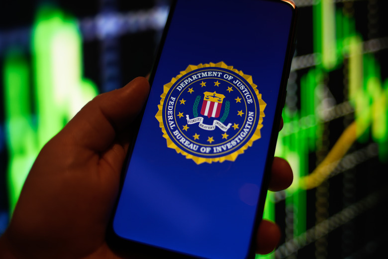 The FBI (Federal Bureau of Investigation) logo is seen on a Redmi phone screen in this photo illustration in Warsaw, Poland on 23 August, 2022. (Photo by STR/NurPhoto via Getty Images)