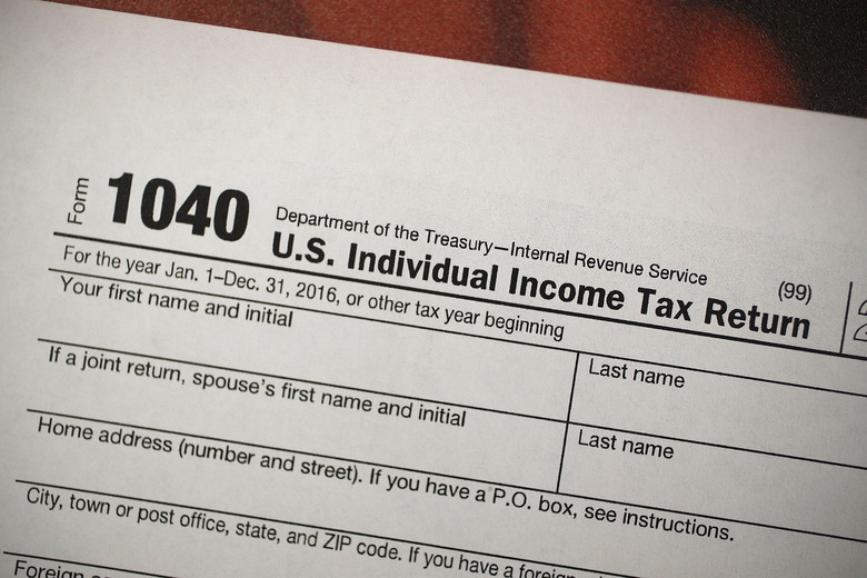MIAMI, FL - DECEMBER 22:  A copy of a IRS 1040 tax form is seen at an H&R Block office on the day President Donald Trump signed the Republican tax cut bill in Washington, DC  on December 22, 2017 in Miami, Florida. Kathy Pickering, vice president of regulatory affairs and executive director of The Tax Institute at H&R Block released a statement about the new tax bill saying, 