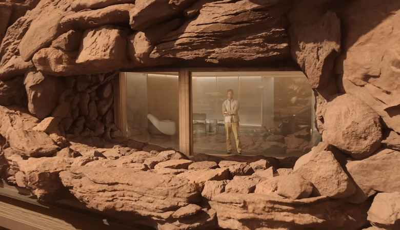 A man on Mars behind glass.