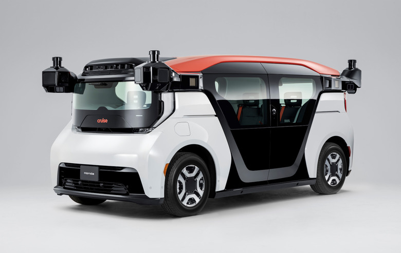 A white vehicle with orange roof and black doors.