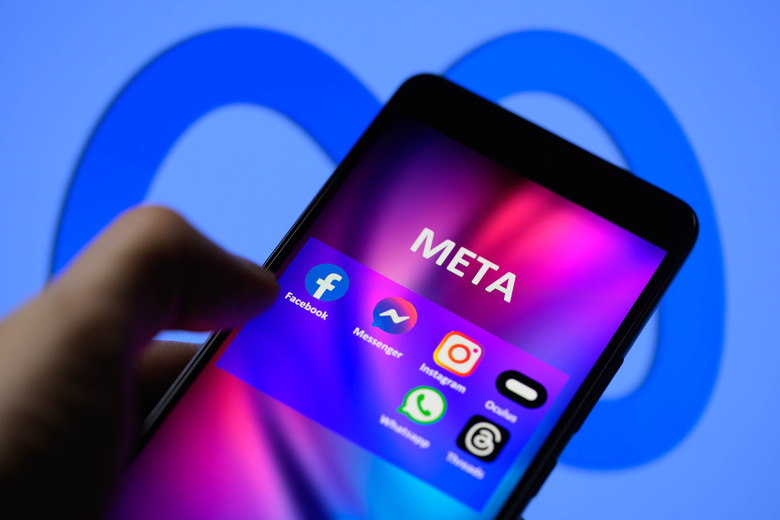 Meta social media icons are being displayed on a smartphone among Facebook, Messenger, Instagram, Threads, and other products, with the Meta icon visible in the background. Facebook, which was founded 20 years ago, is seen in this photo illustration taken in Brussels, Belgium, on February 4, 2024. (Photo by Jonathan Raa/NurPhoto via Getty Images)