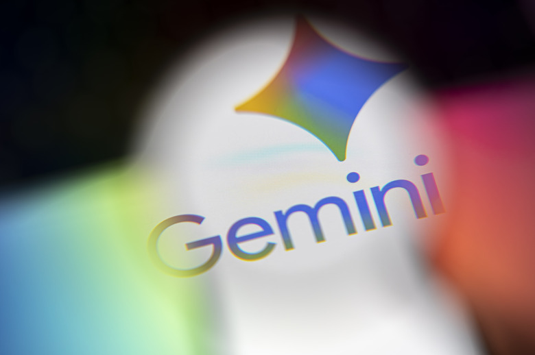 This illustrative photo shows the logo of Google's artificial intelligence (AI) application, Gemini, displayed on a smartphone screen seen through a magnifying glass illuminated by colored light in Creteil, France, on November 11, 2025. (Photo by Samuel Boivin/NurPhoto via Getty Images)