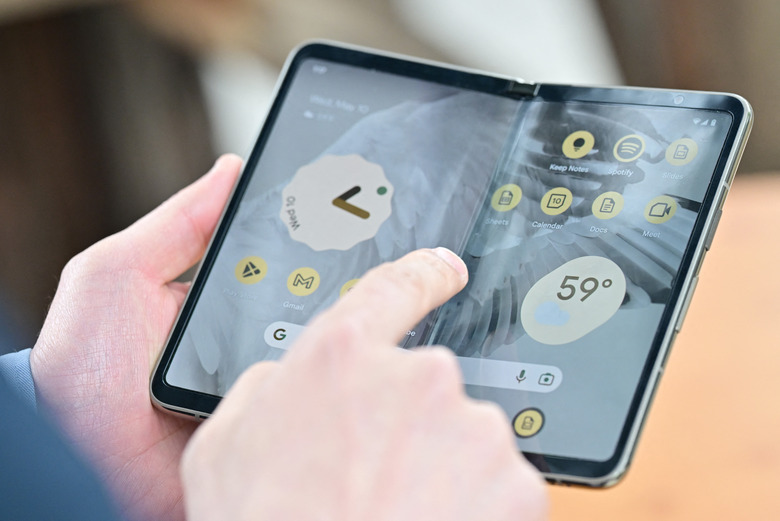 Members of the media view the new Google Pixel Fold phone during the Google I/O annual developers conference at Shoreline Amphitheatre in Mountain View, California on May 10, 2023. (Photo by Josh Edelson / AFP) (Photo by JOSH EDELSON/AFP via Getty Images)