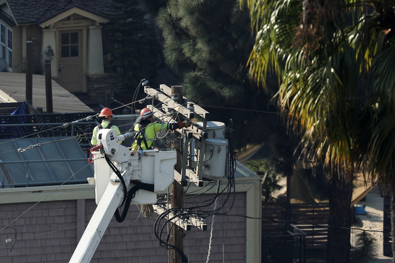 Electricians work to restore power following the Palisades Fire at the Pacific Palisades neighborhood in Los Angeles, California, U.S. January 10, 2025. REUTERS/Mike Blake