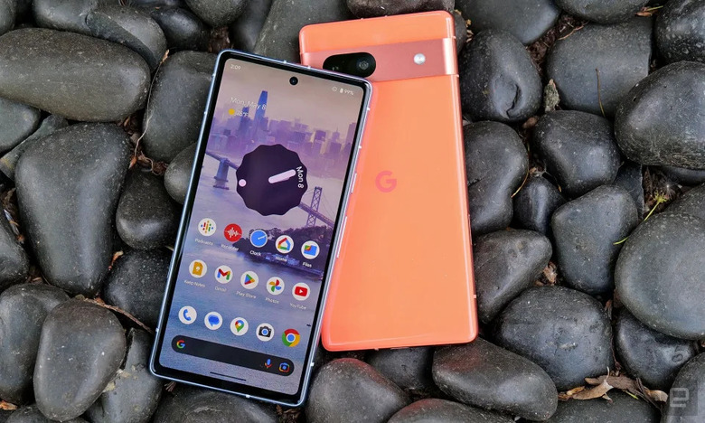 Photo of two Pixel 7a phones — on atop the other, on dark stones.