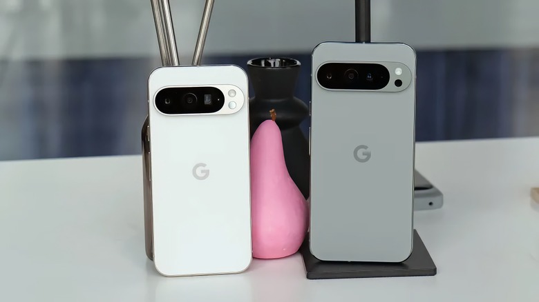 A white Pixel 9 Pro and gray Pixel 9 Pro XL sitting next to each other, with backs facing forward.