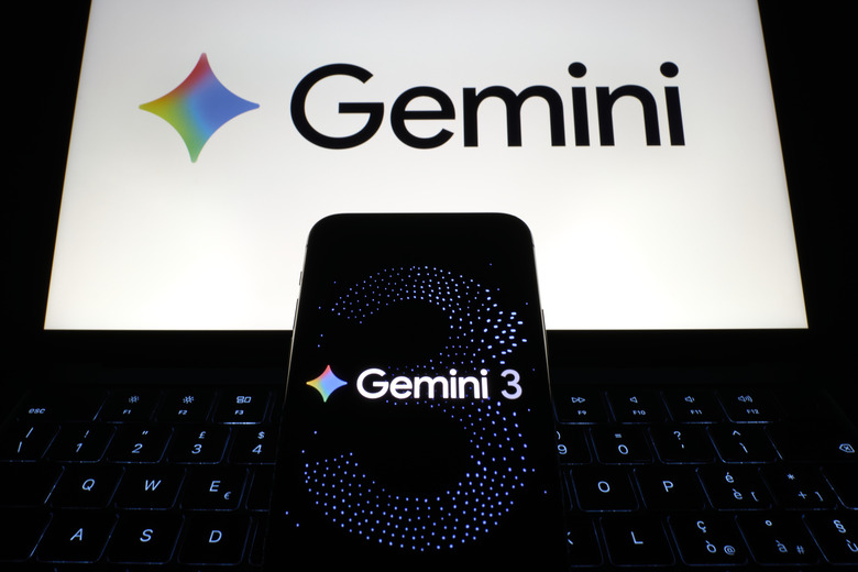 A smartphone displays the Gemini 3 logo in front of a laptop screen showing the Gemini branding during a demonstration in San Ferdinando di Puglia, Italy, on December 4, 2025. The image depicts Google's AI system showcased across multiple digital devices. (Photo by Matteo Della Torre/NurPhoto via Getty Images)