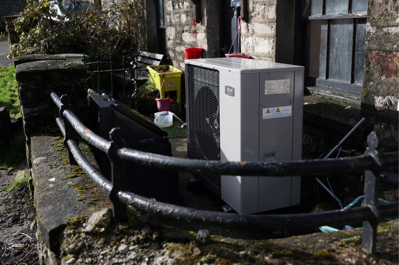 An Ideal Heating heat pump is seen in front of a cottage in Newbiggin-on-Lune, Britain, February 18, 2024. REUTERS/Suzanne Plunkett