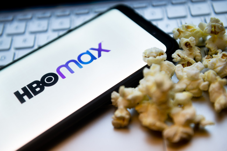 POLAND - 2022/02/03: In this photo illustration a HBO Max logo seen displayed on a smartphone with popcorns and laptop keyboard in the background. (Photo Illustration by Mateusz Slodkowski/SOPA Images/LightRocket via Getty Images)