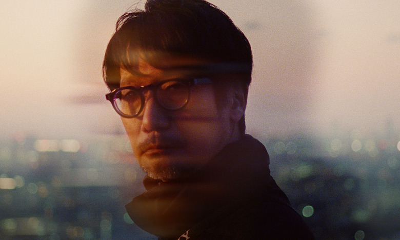 Poster art for the documentary Hideo Kojima: Connecting Worlds. The game designer looks into the camera with dramatic colors and effects.