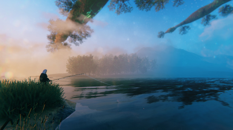 A character in Valheim is sitting on an embankment and fishing. Fog masks distant trees and mountains.