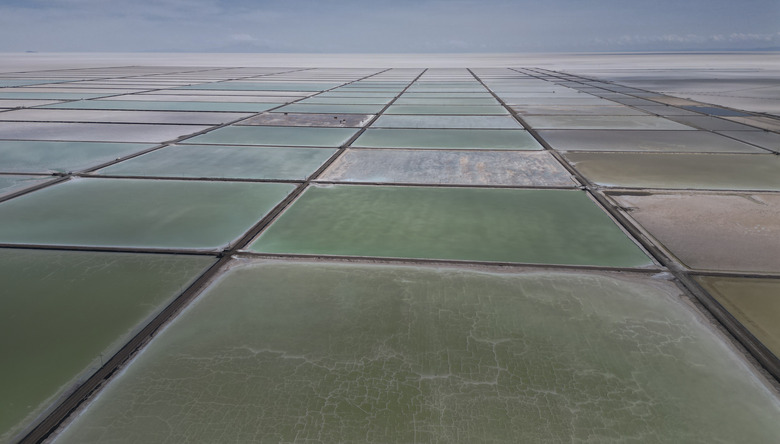 Aerial view of the salt recovery pools in different degrees of evaporation at an industrial plant that produces lithium carbonate to manufacture lithium batteries, after the plant's opening ceremony in the Uyuni salt desert on the outskirts of Llipi, Bolivia, Friday, Dec. 15, 2023. (AP Photo/Juan Karita)