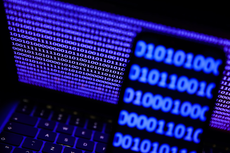 A binardy code displayed on a laptop screen and a binary code displayed on a phone screen are seen in this illustration photo taken in Krakow, Poland on October 30, 2023. (Photo by Jakub Porzycki/NurPhoto via Getty Images)