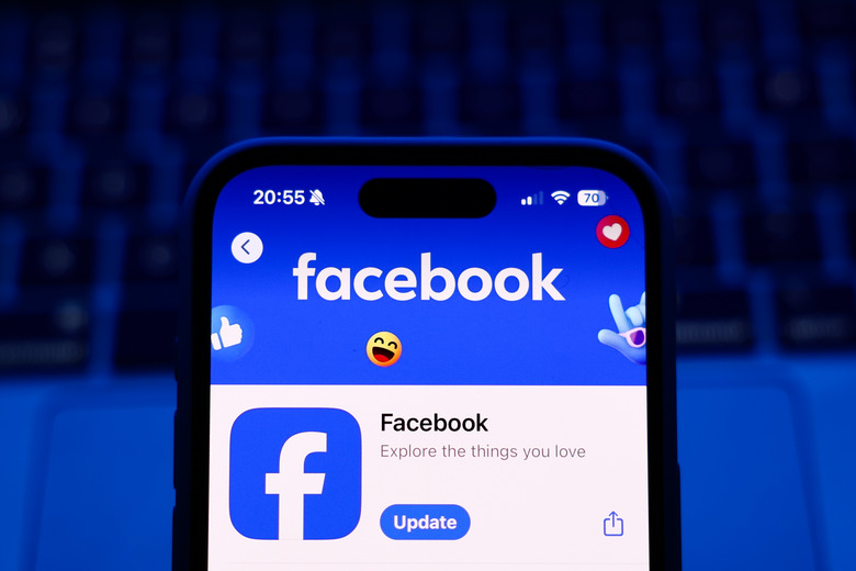 A laptop keyboard and Facebook on App Store displayed on a phone screen are seen in this illustration photo taken in Poland on October 8, 2024. (Photo by Jakub Porzycki/NurPhoto via Getty Images)
