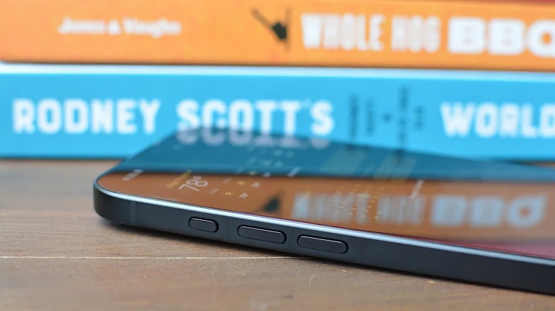 The side of a black iPhone 16 with Action Button showing.