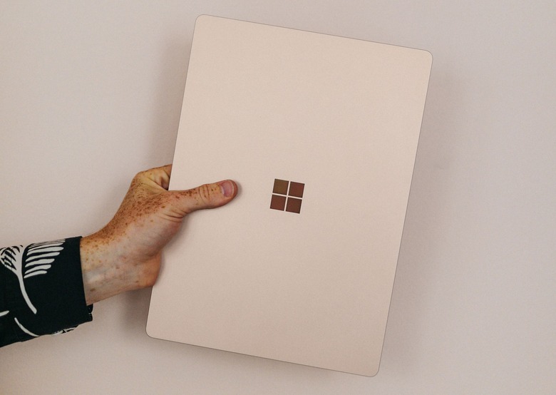 A hand holding a Microsoft device. 