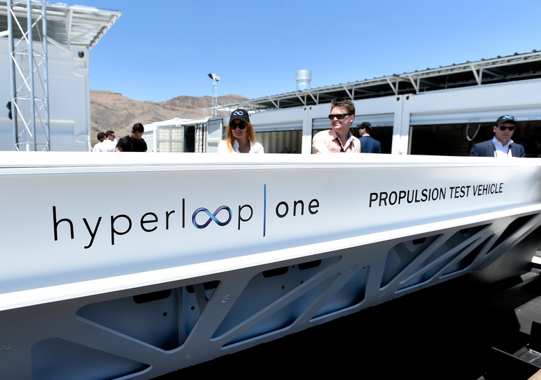 NORTH LAS VEGAS, NV - MAY 11:  People look at a demostration test sled after the first test of the propulsion system at the Hyperloop One Test and Safety site on May 11, 2016 in North Las Vegas, Nevada. The company plans to create a fully operational hyperloop system by 2020.  (Photo by David Becker/Getty Images,)