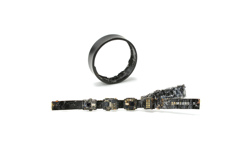 A ring and a strip of electronic components against a white background.
