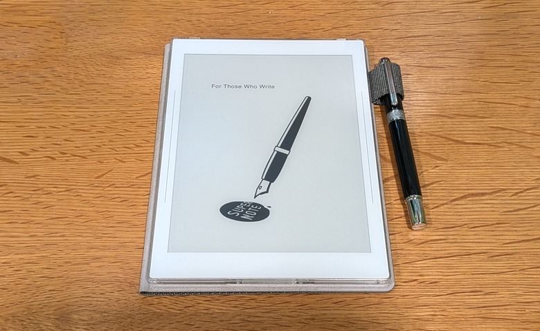 A supernote nomad and heart of metal pen on a wooden desk