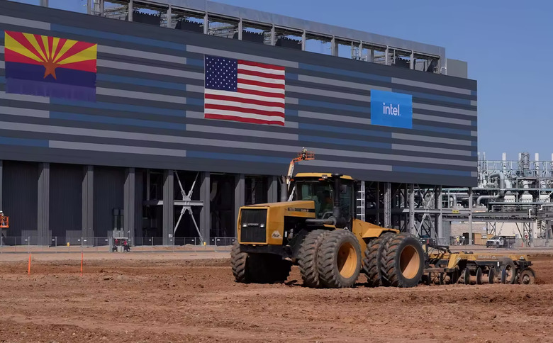 A construction truck in front of a building with the American flag and Intel's logo.