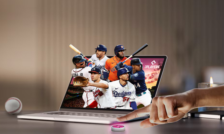 Promotional image for T-Mobile and Major League Baseball’s annual subscription deal for fans. Six MLB players are popping out of a laptop screen as a hand reaches into the frame to press a pink button on the desk in front of the laptop.