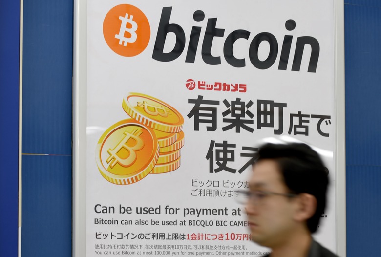 This picture taken on April 7, 2017 shows a man walking past a signboard informing  customers that Bitcoin can be used for payment at a store in Tokyo.
Frenchman Mark Karpeles, former CEO of collapsed Bitcoin exchange MtGox, heads to trial in Tokyo on July 11, 2017 on charges stemming from the disappearance of hundreds of millions of dollars worth of the virtual currency from its digital vaults.  / AFP PHOTO / Toru YAMANAKA        (Photo credit should read TORU YAMANAKA/AFP via Getty Images)