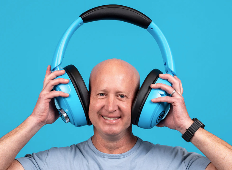A guy wearing huge headphones.