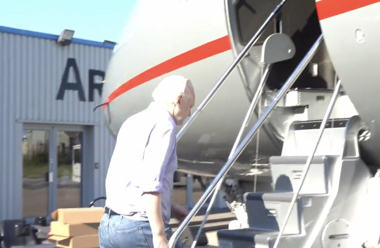 A man climbing the steps to a plane.