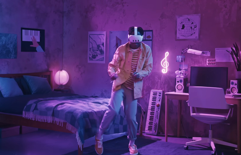 A person dancing in the middle of his room wearing a virtual reality headset.