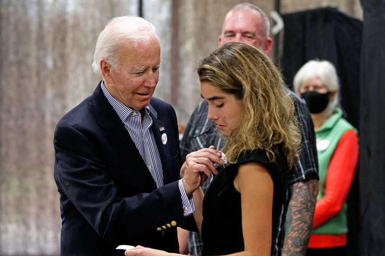 US President Joe Biden placed an 'voted' sticker on granddaughter Natalie Biden after they voted early, in Wilmington, Delaware on October 29, 2022. - Natalie Biden is a first-time voter and daughter of the late Beau Biden. 