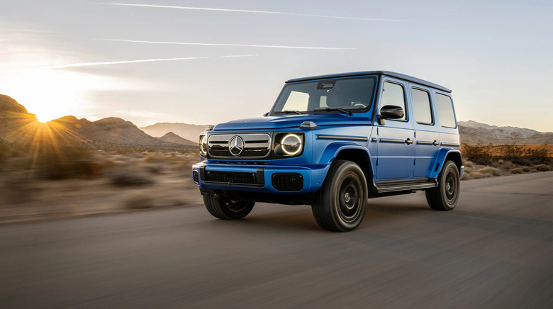 The Mercedes-Benz G580 with EQ technology in blue, driving along a desert road.