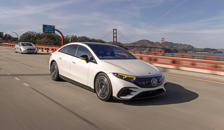 A Mercedes-Benz EV driving in San Francisco, with the Golden Gate Bridge in the background. 