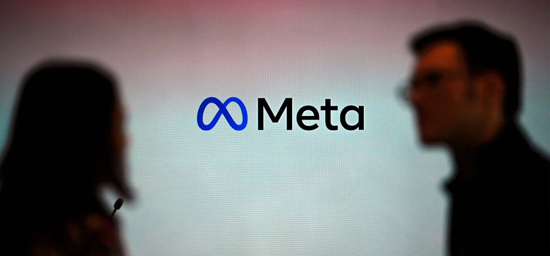 Visitors stand in front of a Meta logo during a launch event at the corporate offices of Meta in Berlin on June 6, 2023. (Photo by Tobias SCHWARZ / AFP) (Photo by TOBIAS SCHWARZ/AFP via Getty Images)