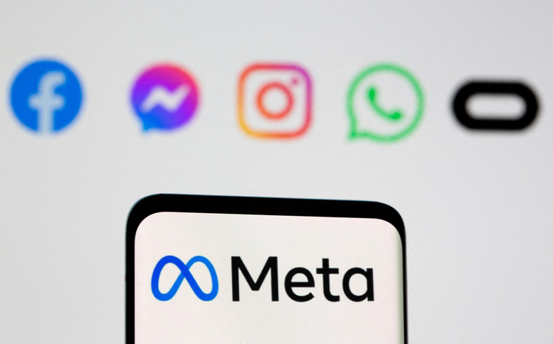 FILE PHOTO: Facebook's new rebrand logo Meta is seen on smartpone in front of displayed logo of Facebook, Messenger, Intagram, Whatsapp, Oculus in this illustration picture taken October 28, 2021. REUTERS/Dado Ruvic/Illustration/File Photo
