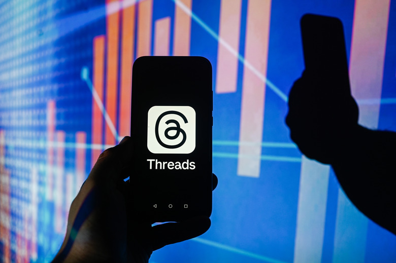 POLAND - 2023/12/14: In this photo illustration a Meta Threads logo is displayed on a smartphone with stock market percentages in the background. (Photo Illustration by Omar Marques/SOPA Images/LightRocket via Getty Images)