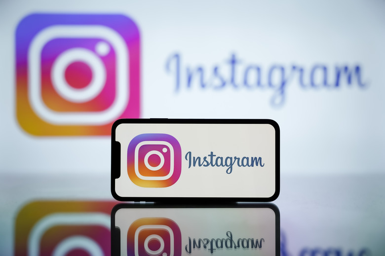INDIA - 2024/04/27: In this photo illustration, the Instagram logo is seen displayed on a mobile phone screen and in the background. (Photo Illustration by Idrees Abbas/SOPA Images/LightRocket via Getty Images)