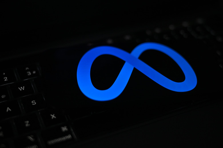 ANKARA, TURKIYE - JULY 21: In this photo illustration, the 'Meta' logo is displayed on a mobile phone screen in front of a computer in Ankara, Turkiye on July 21, 2024. (Photo by Muhammed Abdullah Kurtar/Anadolu via Getty Images)