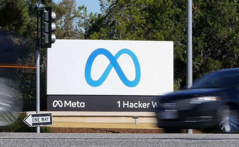 FILE - A car passes Facebook's new Meta logo on a sign at the company headquarters on Oct. 28, 2021, in Menlo Park, Calif. Big tech platforms say they are working hard to address misinformation about voting and elections ahead of the November 2022 midterms, but a look at their sites shows they are still struggling to contend with false claims from 2020. (AP Photo/Tony Avelar, File)