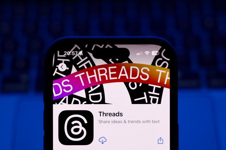 A laptop keyboard and Threads on App Store displayed on a phone screen are seen in this illustration photo taken in Poland on October 8, 2024. (Photo by Jakub Porzycki/NurPhoto via Getty Images)