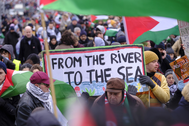 BRUSSELS, BELGIUM - JANUARY 21: About 9,000 people take part in a demonstration between the 'Gare du Nord' and the 'Place Jean Rey' on January 21, 2024, in Brussels, Belgium. People hold a placard with 'From the river to the sea » written. A national march bringing together around 9,000 people (according to figures from the Brussels-Capital) was held this Sunday afternoon to demand from Belgium 