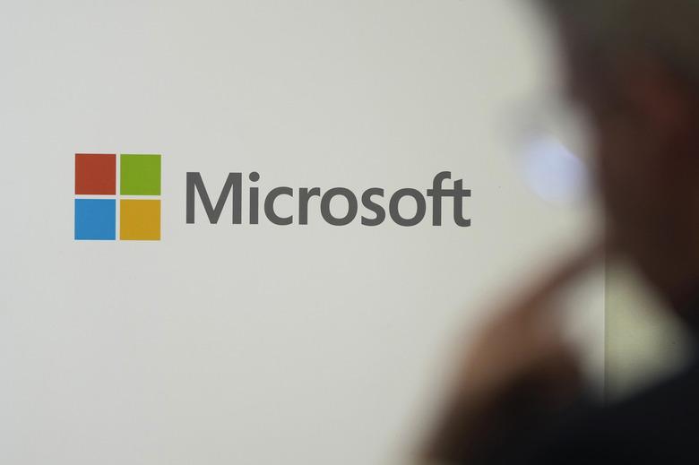 FILE - A logo of Microsoft is displayed during an event at the Chatham House think tank in London, Monday, Jan. 15, 2024. On Friday, Feb. 9, The Associated Press reported on stories circulating online incorrectly claiming Microsoft plans to “disable computers of users who share ‘non-mainstream content’ online.” (AP Photo/Kin Cheung, File)