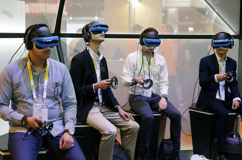 PARIS, FRANCE - MAY 24:  Visitors play a video game with the Acer Windows Mixed Reality Headset during the Viva Technologie show at Parc des Expositions Porte de Versailles on May 24, 2018 in Paris, France.  Viva Technology, the new international event brings together 5,000 startups with top investors, companies to grow businesses and all players in the digital transformation who shape the future of the internet.  (Photo by Chesnot/Getty Images)
