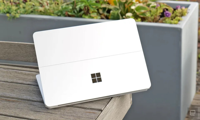 A white device with the Microsoft Windows logo on top of a wooden bench.