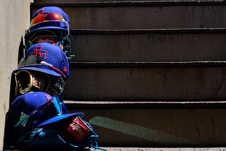 Apr 1, 2022; Scottsdale, Arizona, USA; General view of Texas Rangers hats and gloves prior to the game against the San Francisco Giants at Scottsdale Stadium. Mandatory Credit: Matt Kartozian-USA TODAY Sports