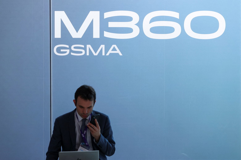 A man uses a mobile phone, as he attends the Mobile World Congress (MWC) in Barcelona, Spain, February 27, 2024. REUTERS/Bruna Casas
