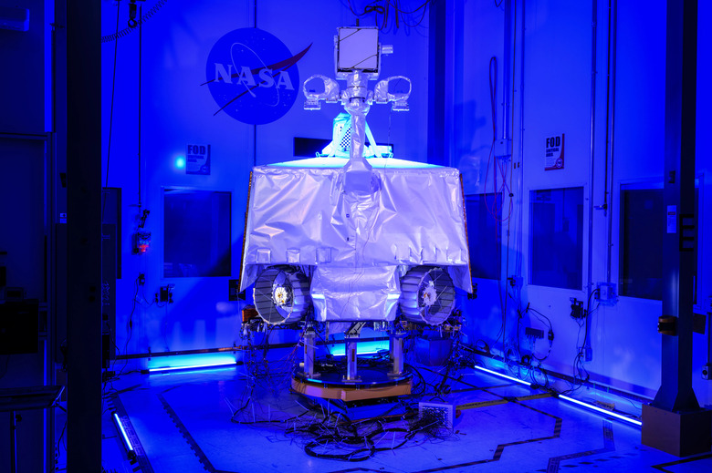 A contraption inside a room with the NASA logo in the background.